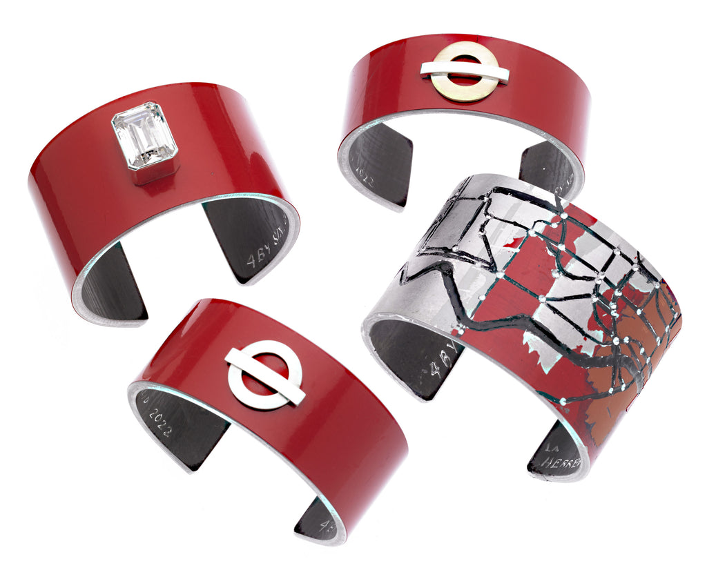 Group of bracelets made out of the panels from a London doubledecker bus.