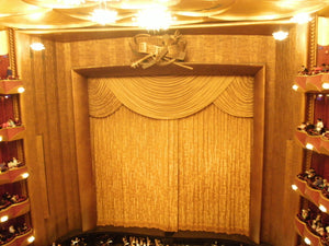 golden silk curtain at the metropolitan opera